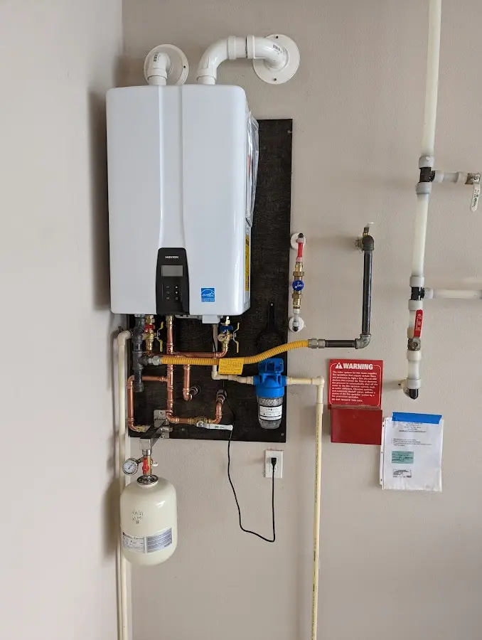 Professional plumber installing copper piping in a Summit Park home